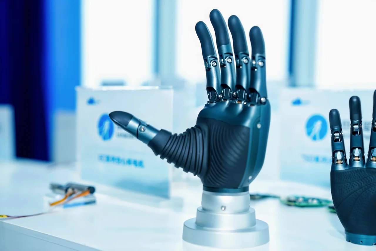 Close-up of a dexterous robotic hand on a display stand.
