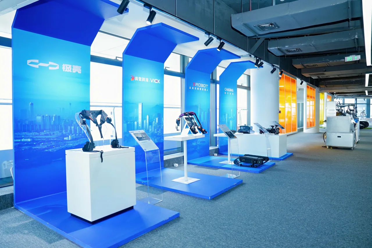 Blue exhibition booths displaying wearable exoskeletons and compact robots.